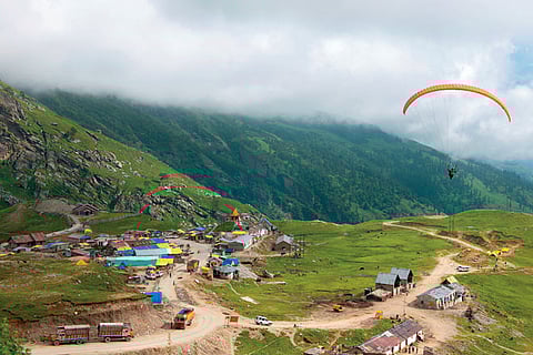 A paraglider over the settlement of Marhi