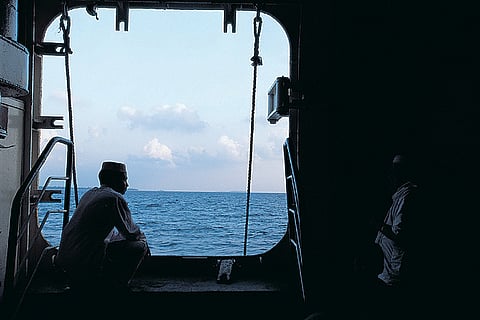 The water is slate grey at first, then as the sun rises, it separates the dark blue of the open sea from the lace-edged aquamarine of the lagoon