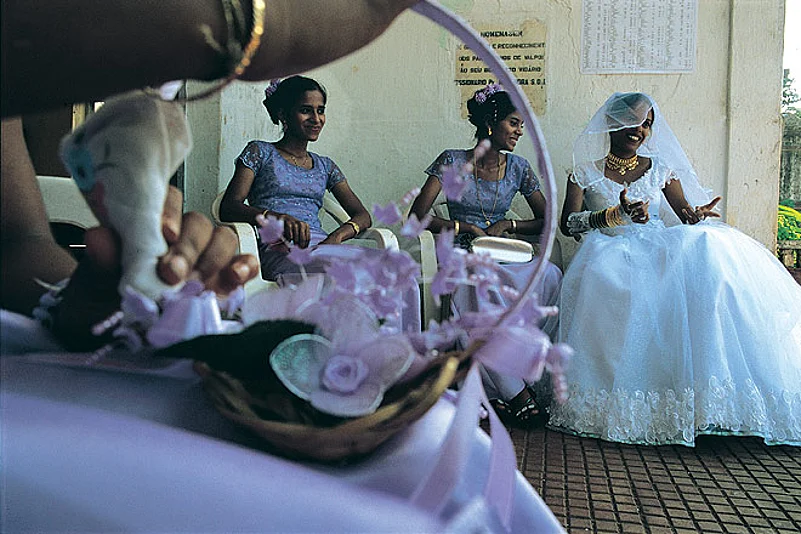 A bride-to-be and her flower girls wait outside a church ahead of the wedding