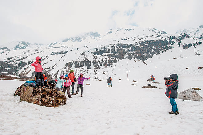 A family capturing images in the snow