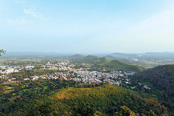 A short trek uphill or a 20-minute drive brings one atop the hill, which offers panoramic viewslush green on one side, houses, lakes