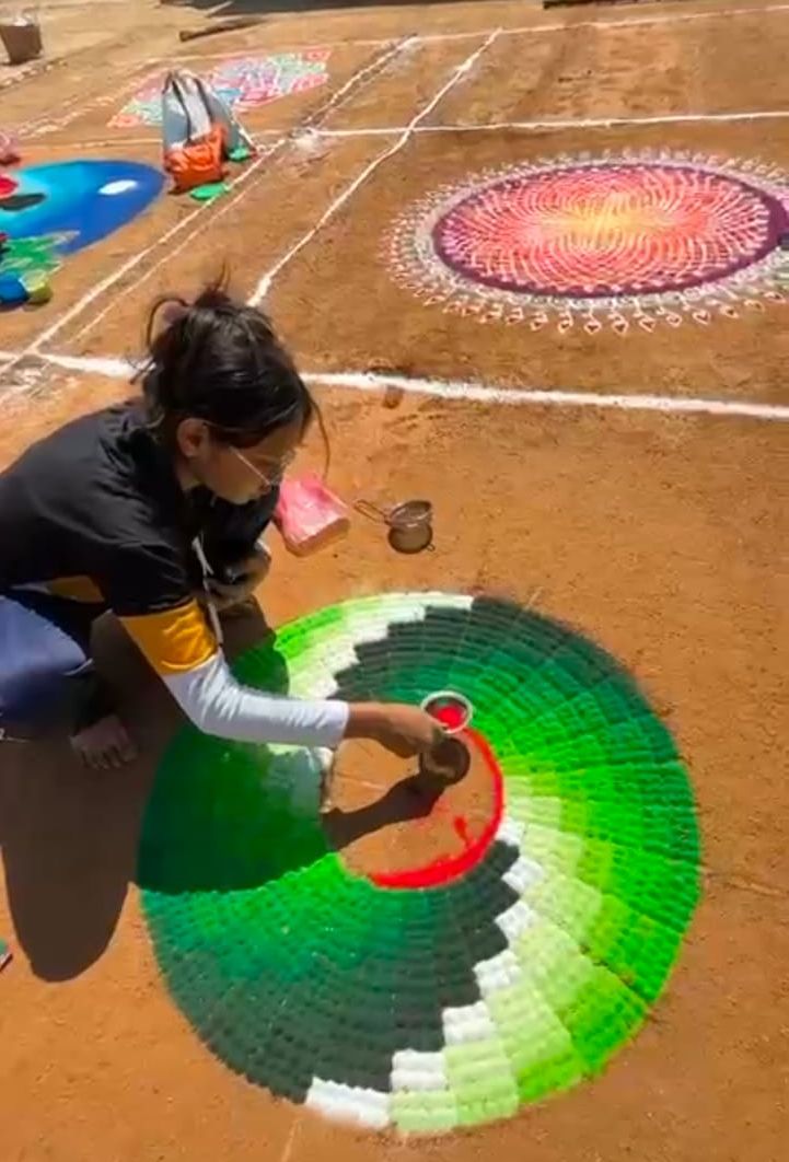  ಛಾಯಾ ಸಂಕ್ರಾಂತಿ ಸಂಭ್ರಮದಲ್ಲಿ ರಂಗೋಲಿ ಬಿಡಿಸುವಲ್ಲಿ ನಿರತರಾಗಿರುವ ಯುವತಿ