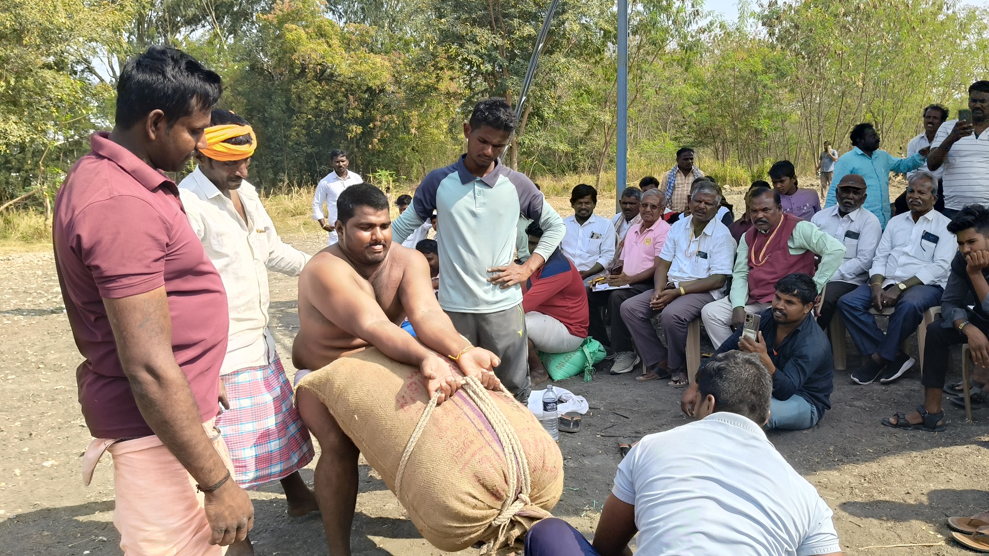 ಉಸುಕಿನ ಚೀಲ ಎತ್ತುತ್ತಿರುವ ಸಾಹಸಿ ಕ್ರೀಡಾಪಟು