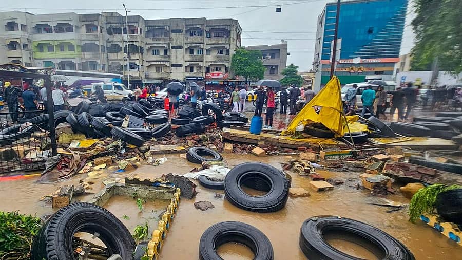 ಮಳೆಯಿಂದಾಗಿ ಜುನಾಗಢ್ನಲ್ಲಿ ರಾಜ್ಯ ಸಾರಿಗೆ ಬಸ್ ಕಾರ್ಯಾಗಾರದ ಗೋಡೆ ಕುಸಿದು ಟೈರ್ಗಳು ಹರಡಿರುವುದು –ಪಿಟಿಐ ಚಿತ್ರ