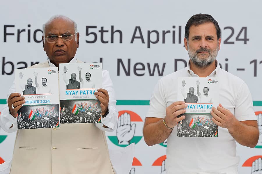Rahul Gandhi, a senior leader of India's main opposition Congress Party and Mallikarjun Kharge, President of the Congress Party, display the party's manifesto for the general election in New Delhi, India, April 5, 2024. REUTERS/Adnan Abidi