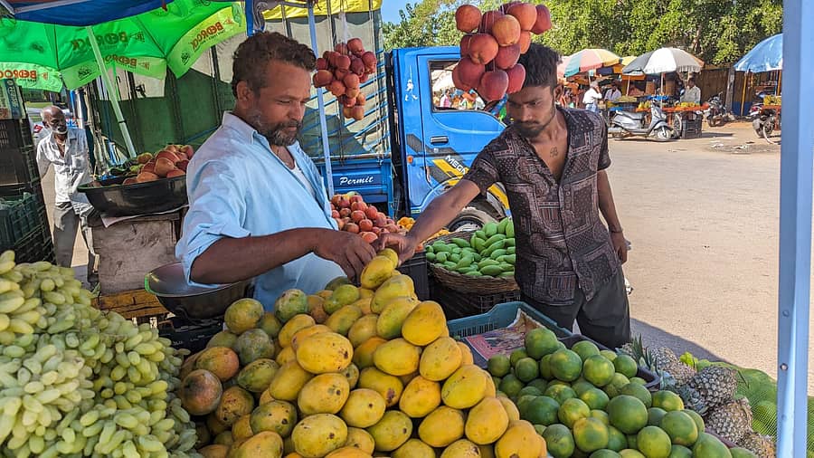 ಚಾಮರಾಜನಗರದ ಹಣ್ಣಿನ ಮಳಿಗೆಯೊಂದರಿಂದ ಗ್ರಾಹಕರೊಬ್ಬರು ಮಾವಿನ ಹಣ್ಣು ಖರೀದಿಸಿದರು