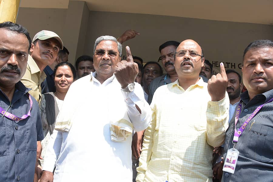 ಸಿದ್ದರಾಮನಹುಂಡಿ ಮತಗಟ್ಟೆಯಲ್ಲಿ ಶುಕ್ರವಾರ ಮತ ಚಲಾವಣೆ ಬಳಿಕ ಮುಖ್ಯಮಂತ್ರಿ ಸಿದ್ದರಾಮಯ್ಯ ಹಾಗೂ ಅವರ ಪುತ್ರ ಡಾ. ಯತೀಂದ್ರ ಶಾಯಿ ಹಚ್ಚಿದ ಬೆರಳು ತೋರಿದರು