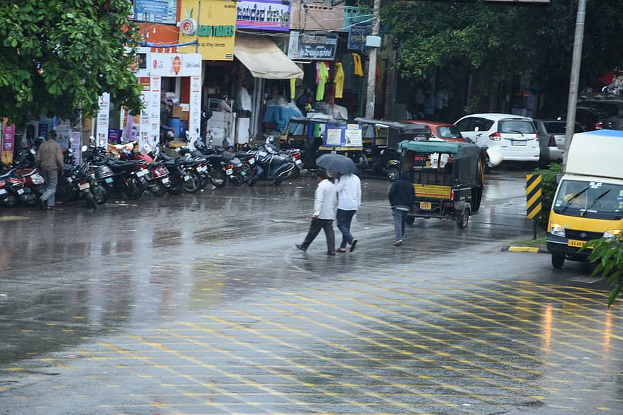 ತುಂತುರು ಮಳೆ ಸುರಿಯುವ ವೇಳೆ ಚಿಕ್ಕಬಳ್ಳಾಪುರದಲ್ಲಿ ಕೊಡೆ ಹಿಡಿದು ನಡೆದ ನಾಗರಿಕರು