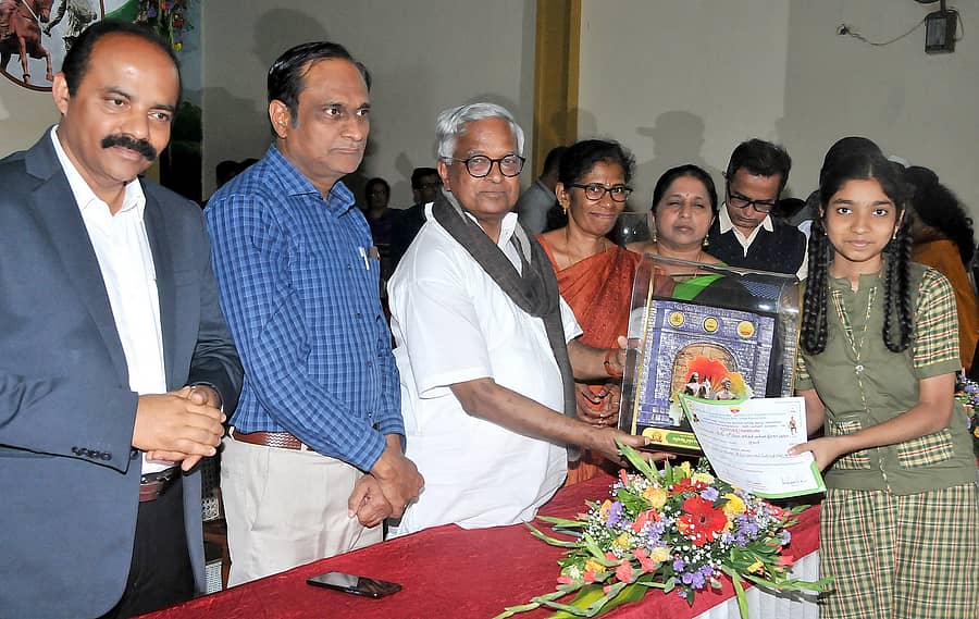 ಪ್ರಬಂಧ ಸ್ಪರ್ಧೆಯಲ್ಲಿ ವಿಜೇತರಾದ ವಿದ್ಯಾರ್ಥಿಯೊಬ್ಬರಿಗೆ ಪುರುಷೋತ್ತಮ ಬಿಳಿಮಲೆ ಅವರು ಪ್ರಶಸ್ತಿ ಪತ್ರ ಹಾಗೂ ನೆನಪಿನ ಕಾಣಿಕೆಗಳನ್ನು ವಿತರಿಸಿದರು