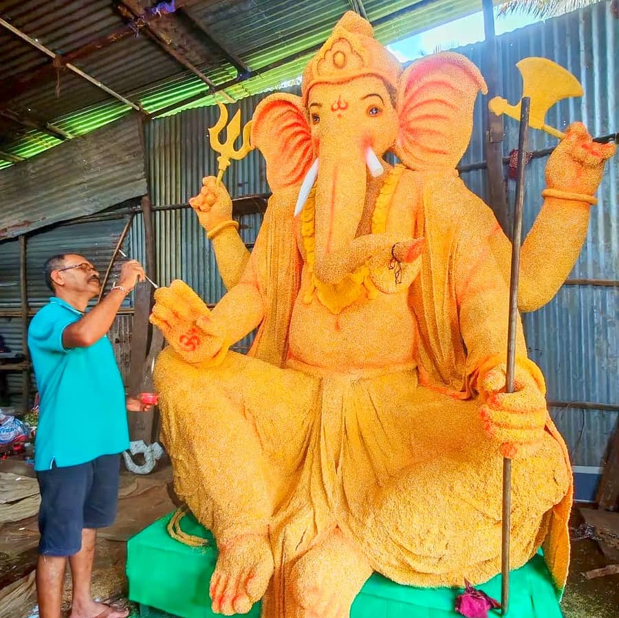 ಗೋವಿನಜೋಳದ ಕಾಳು ಬಳಸಿ ಸಿದ್ಧಪಡಿಸಲಾದ ಗಣೇಶ ಮೂರ್ತಿಗೆ ಕಲಾವಿದ ಸುನೀಲ ಆನಂದಾಚೆ ಅಂತಿಮ ಸ್ಪರ್ಶ ನೀಡುತ್ತಿರುವುದು