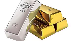 Gold and silver coins and bars on a market table