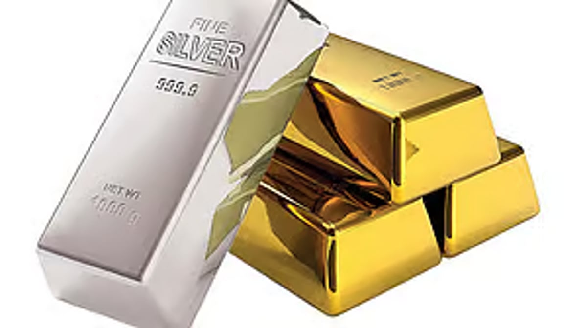 Gold and silver coins and bars on a market table