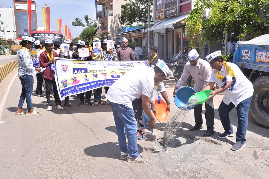ಕೋಲಾರದಲ್ಲಿ ಗುರುವಾರ ಆಮ್ ಆದ್ಮಿ ಪಕ್ಷದ ಜಿಲ್ಲಾಧ್ಯಕ್ಷ ಕೆ.ಪಿ.ವೆಂಕಟಾಚಲಪತಿ ಹಾಗೂ ಉಸ್ತುವಾರಿ ಸುರೇಶ್ ಬಾಲಕೃಷ್ಣ ನೇತೃತ್ವದಲ್ಲಿ ಕಾರ್ಯಕರ್ತರು ರಸ್ತೆ ಗುಂಡಿ ಮುಚ್ಚಿ ಪ್ರತಿಭಟನೆ ನಡೆಸಿದರು