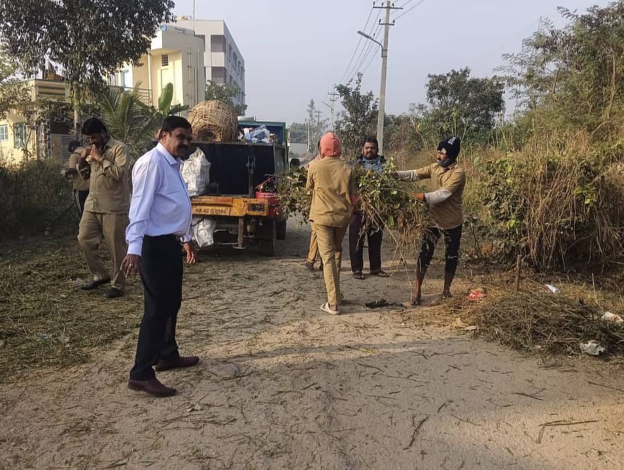 ಕನಕಪುರ ಬಿಜಿಎಸ್ ಬಡಾವಣೆಯಲ್ಲಿ ನಗರಸಭೆ ಪೌರಾಯುಕ್ತ ಶ್ರೀನಿವಾಸ್ ನಿಂತು ಸ್ವಚ್ಛತೆ ಕಾರ್ಯ ಮಾಡಿಸುತ್ತಿರುವುದು