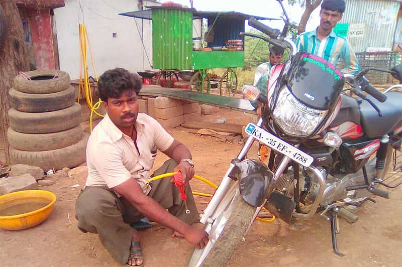 ಮುಂಡರಗಿ ತಾಲ್ಲೂಕಿನ ಜ್ಯಾಲವಾಡಿಗೆ ಗ್ರಾಮದಲ್ಲಿ ದ್ವಿಚಕ್ರ ವಾಹನಕ್ಕೆ ಪಂಕ್ಚರ್ ಹಾಕುತ್ತಿರುವ ರವಿ ಲಮಾಣಿ