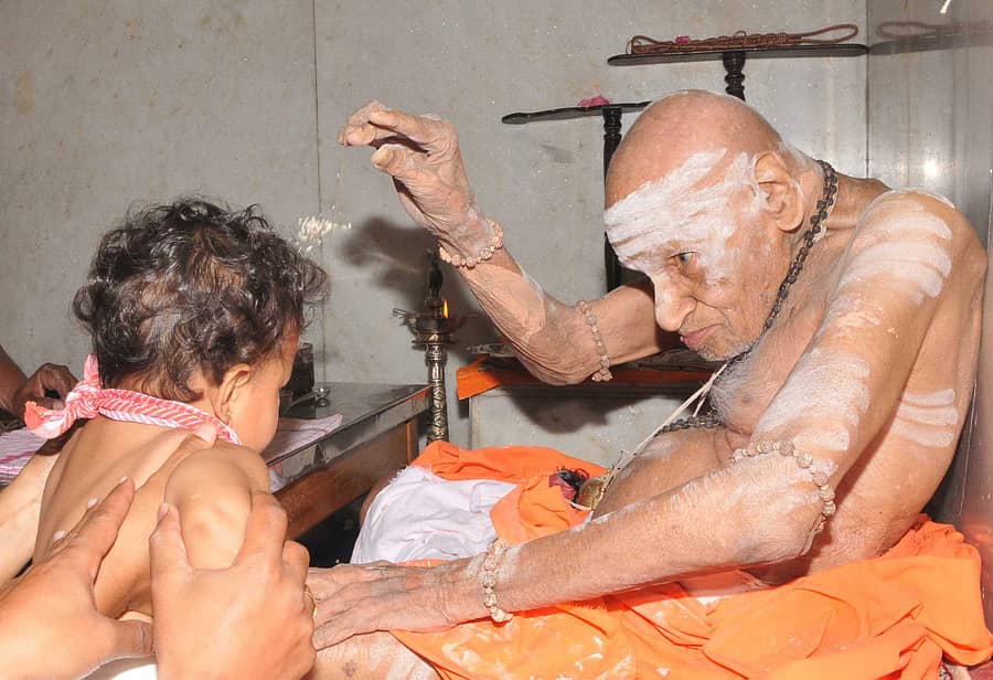 ಪರಶಿವನನ್ನು ಮಗುವಾಗಿಸಿಕೊಂಡ ಸಂತ... ಸಿದ್ಧಗಂಗೆ ಮಠದಲ್ಲಿ ಲಿಂಗಪೂಜೆಯ ನಂತರ ಮಗುವಿಗೆ ಆಶೀರ್ವಾದ ಮಾಡುತ್ತಿರುವ ಶಿವಕುಮಾರ ಸ್ವಾಮೀಜಿ. (ಪ್ರಜಾವಾಣಿ ಚಿತ್ರ: ಎಸ್.ಚಂದನ್)