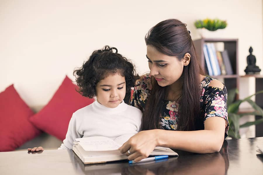 Mother helping daughter with homework