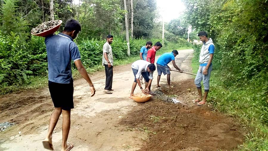 ಮಡಿಕೇರಿ ತಾಲ್ಲೂಕಿನ ಕಾಟಕೇರಿಯಲ್ಲಿ ರಸ್ತೆಗೆ ಕಲ್ಲು–ಮಣ್ಣು ಹಾಕುತ್ತಿರುವ ಗ್ರಾಮಸ್ಥರು