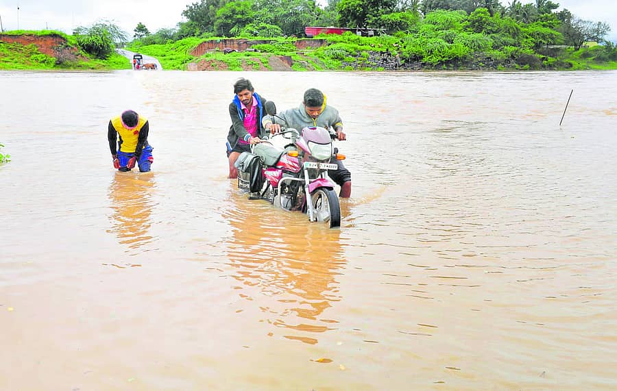 ಹಾವೇರಿ ಜಿಲ್ಲೆಯ ಹಾನಗಲ್ ತಾಲ್ಲೂಕಿನ ಕೂಡಲ ಬಳಿ ಬುಧವಾರ ತುಂಬಿ ಹರಿಯುತ್ತಿದ್ದ ವರದಾ ನದಿಯ ಸೇತುವೆ ಮೇಲೆ ಬೈಕ್ ತಳ್ಳಿಕೊಂಡು ಬಂದ ಸವಾರರು