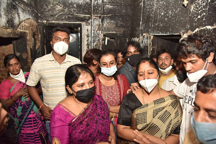 ಗಲಭೆಯಿಂದ ಹಾನಿಗೊಂಡಿರುವ ಮನೆಯಲ್ಲಿ ಕುಟುಂಬ ಸದಸ್ಯರು