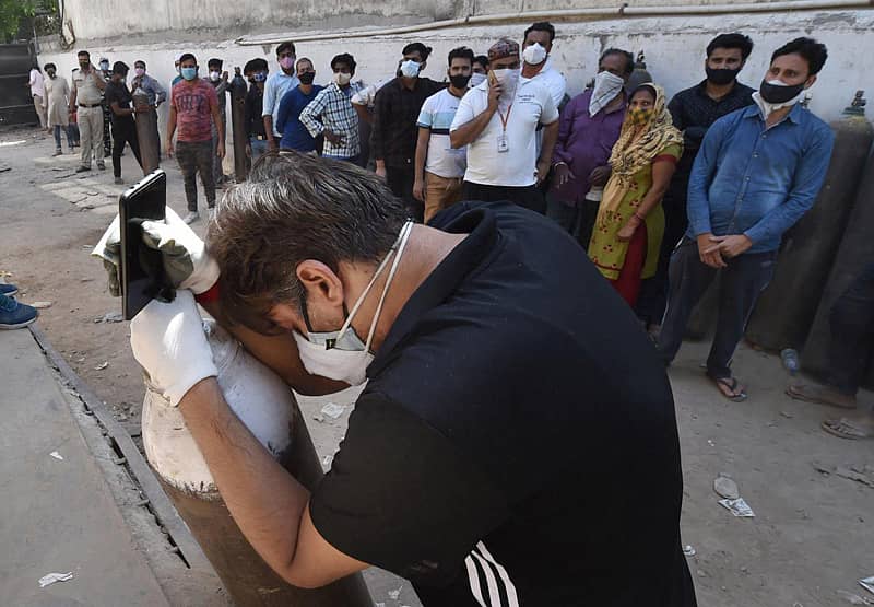 ದೆಹಲಿಯಲ್ಲಿ ಕೋವಿಡ್ ರೋಗಿಯ ಸಂಬಂಧಿಯೊಬ್ಬರು ಆಮ್ಲಜನಕ ಸಿಲಿಂಡರ್ ತುಂಬಿಸಿಕೊಳ್ಳಲು ಆಮ್ಲಜನಕ ಘಟಕದ ಮುಂದೆ ಭಾನುವಾರ ಸರದಿಯಲ್ಲಿ ನಿಂತಿದ್ದರು –ಪಿಟಿಐ ಚಿತ್ರ