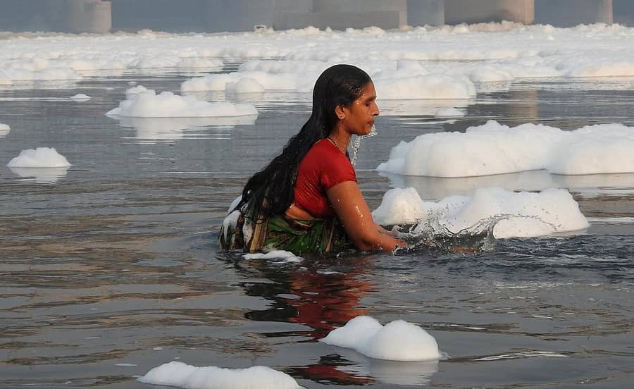 ನೊರೆಪೂರಿತ ಯಮುನಾ ನದಿಯಲ್ಲಿ ಛಠ್ ಪೂಜೆಯ ಪ್ರಯುಕ್ತ ಮುಳುಗಿ ಎದ್ದ ಮಹಿಳೆ