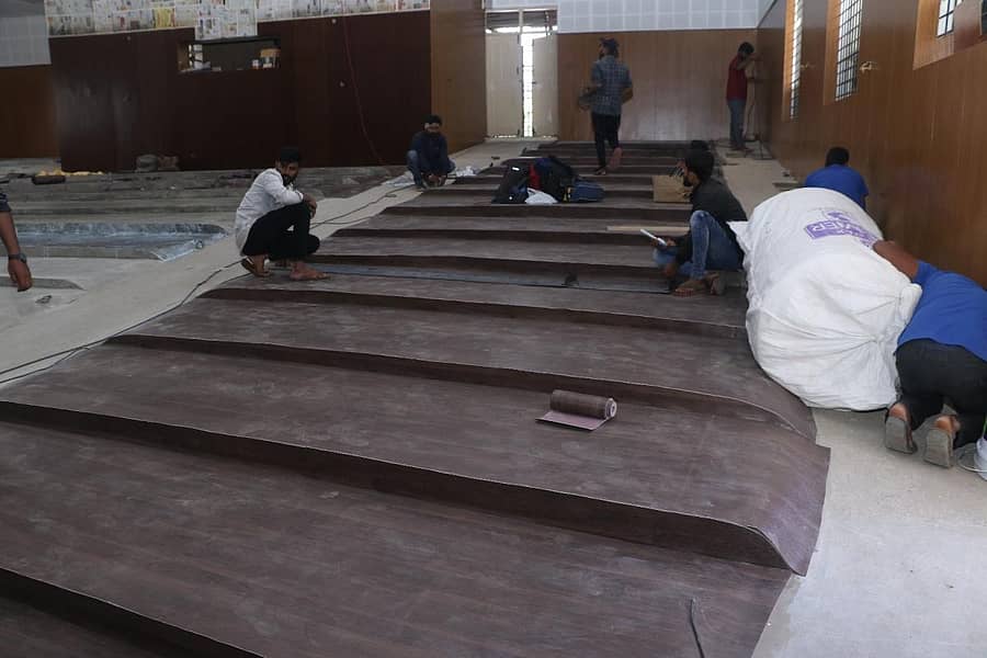 ರಂಗಮಂದಿರದ ಒಳಾಂಗಣದಲ್ಲಿ ಆಸನಗಳನ್ನು ಅಳವಡಿಸಲು ನೆಲವನ್ನು ಸಜ್ಜುಗೊಳಿಸುತ್ತಿರುವುದು