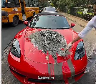 போர்ஷேவில் வந்து சாலையைச் சரிசெய்த தொழிலதிபர்! 