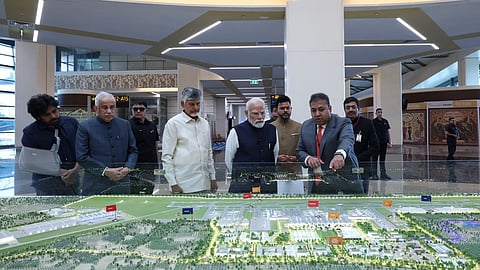 Prime Minister Narendra Modi reviewing an infrastructure project model in Andhra Pradesh.