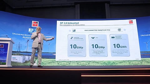 KP Group Chairman Dr. Faruk G. Patel speaks on stage beside a KP 3.0 presentation slide displaying the company’s FY2032 targets for owned renewable energy generation, third-party EPC and battery energy storage manufacturing.