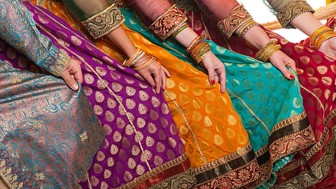Bollywood Dancers are Holding Their Vivid Costumes