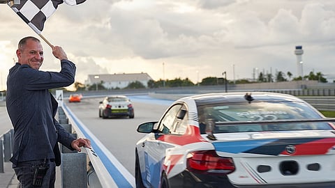 Aaron Weiss Waves the Flag at The Concours Club Finish Line