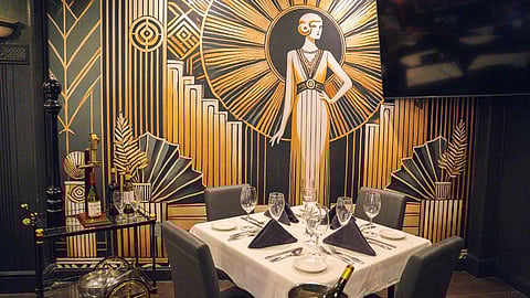Art Deco dining room with gold mural at Maison Ostrow