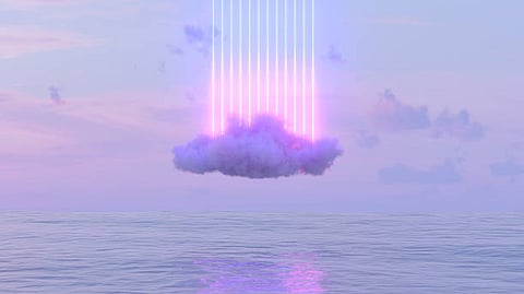 Neon Cloud Installation Over Calm Ocean at Sunset