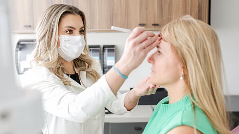 Dr. Marcella Falcão De Souza Bianchin Working with a Patient