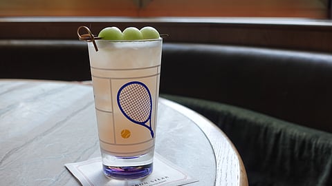 Honey Deuce cocktail with melon garnish at Bourbon Steak NYC