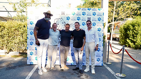 Charity padel winners celebrate on court with medals