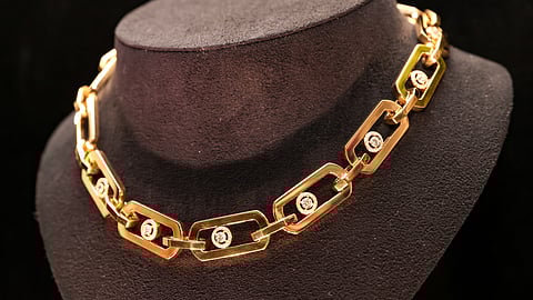 Gold Messika necklace with diamond accents on display at Baker House 1650