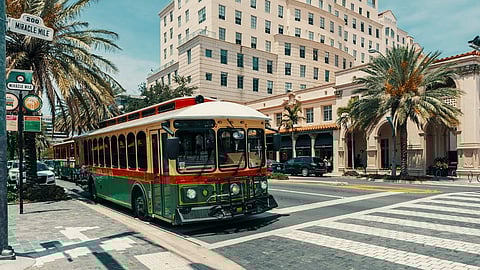 Coral Gables trolley on Miracle Mile with palm trees and shops