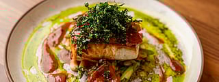 Colorful Peruvian dish topped with greens and sauce at Mission Ceviche
