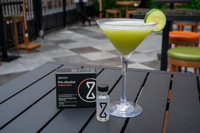 ZBiotics Pre-Alcohol with green cucumber cocktail on Magic Hour rooftop