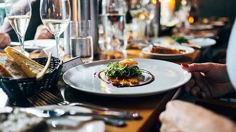 Gourmet dish served at an upscale restaurant with wine glasses