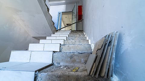 Partially tiled staircase under renovation reveals construction flaws