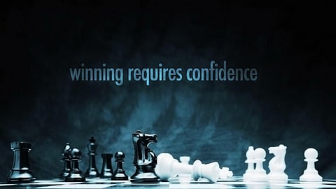 Black and white chess pieces with the phrase “winning requires confidence.”