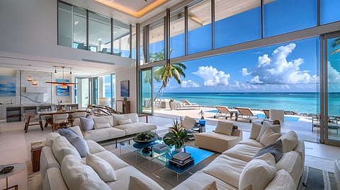 Modern beach home with ocean view through floor-to-ceiling windows