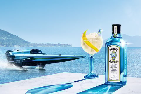 Bombay Sapphire Sparkling Lemon with boat in background and ocean view