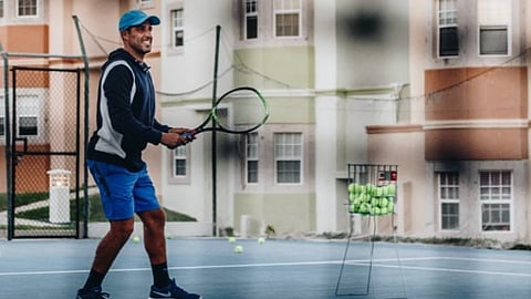 Jonathan Di Pierro holding a tennis racket on court