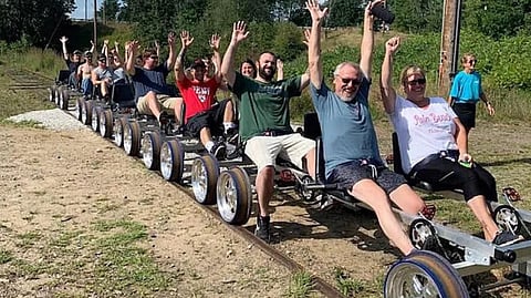 Scenic Rail Riders gliding through lush green forested tracks