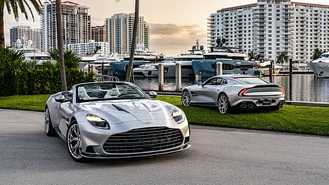 Two Aston Martin Vanquish models displayed by yachts