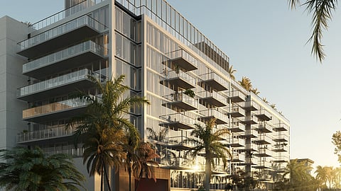 Glass-fronted luxury residences at THE WELL Bay Harbor Islands at sunset.